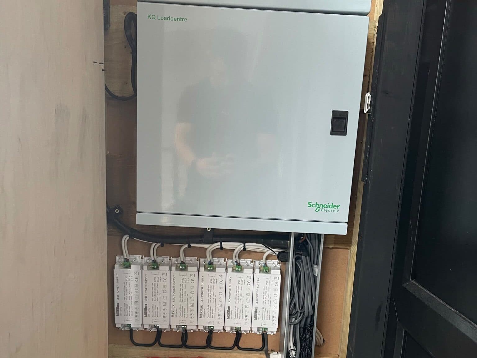 Commercial distribution board with a row of lighting drivers wired in below it