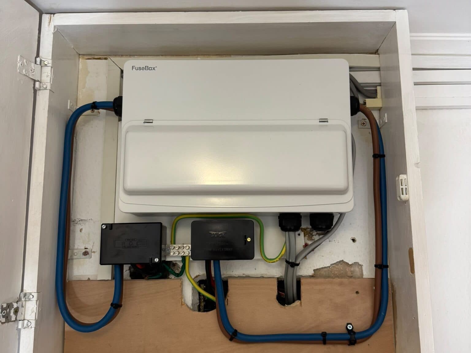 New consumer unit fitted inside a cupboard, with the cables neatly run in