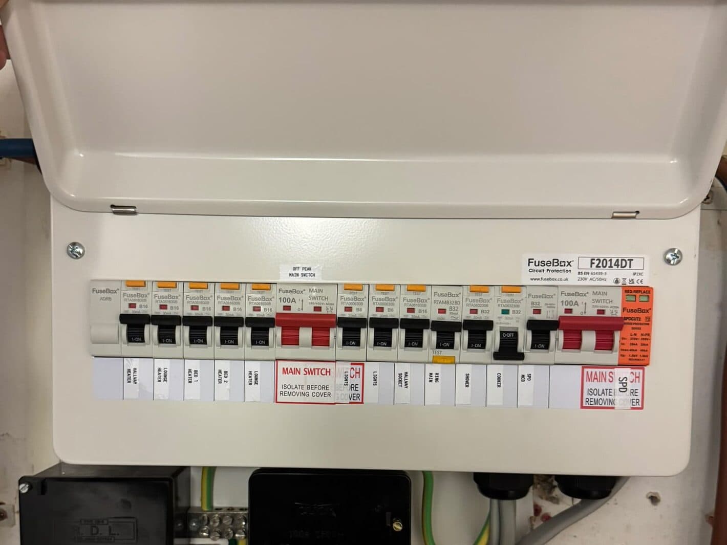 New consumer unit with its cover open, showing the main switch and a row of safety switches